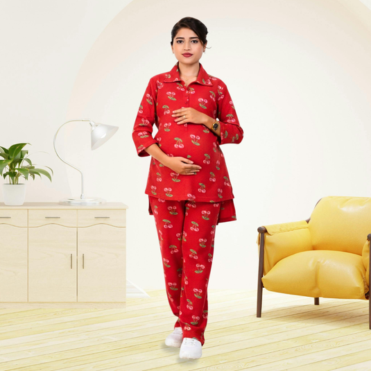 pregnant woman wearing a red pajama set with a pattern in a room with a yellow chair and white cabinet.