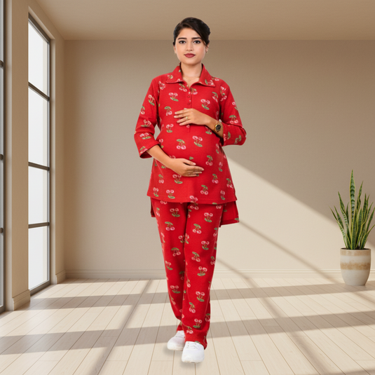 pregnant woman wearing a red pajama set with a pattern in a room with a yellow chair and white cabinet.