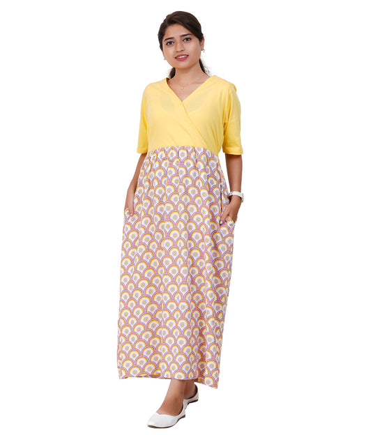 Woman wearing a yellow top and patterned skirt with pockets on a white background