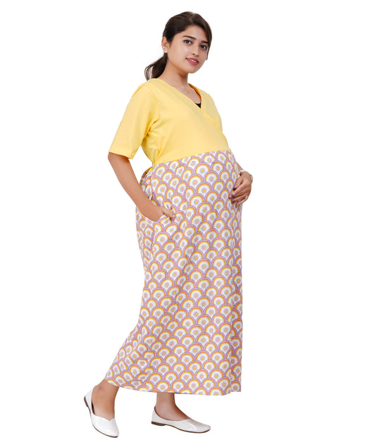 Pregnant Woman wearing a yellow maternity top and patterned skirt on a white background