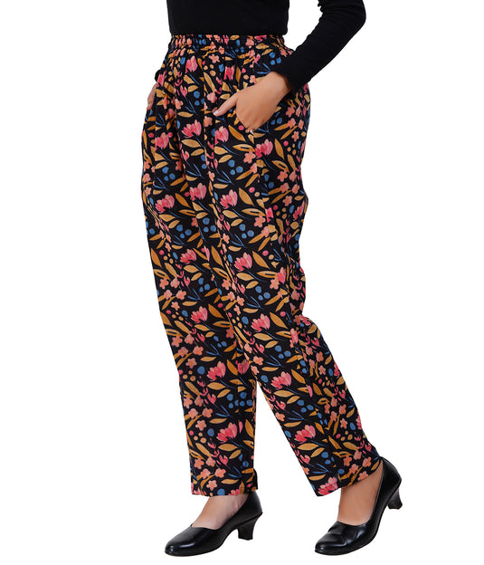 Floral patterned pants worn by a person on a white background