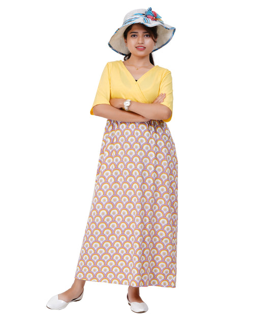 Woman wearing a yellow criss cross top and patterned skirt with a white hat