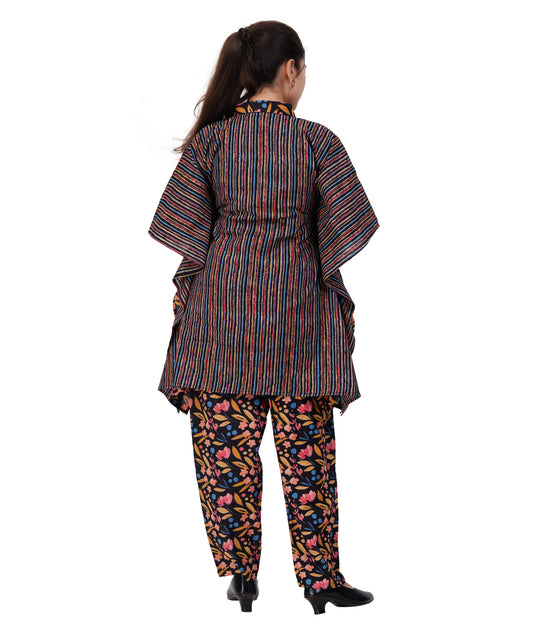 Woman wearing a colorful traditional outfit with a striped top and patterned pants on a white background