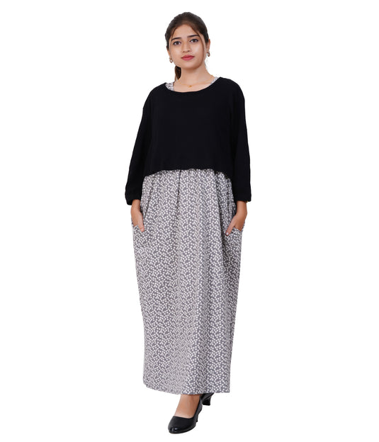 Woman wearing a black top and patterned skirt on a white background