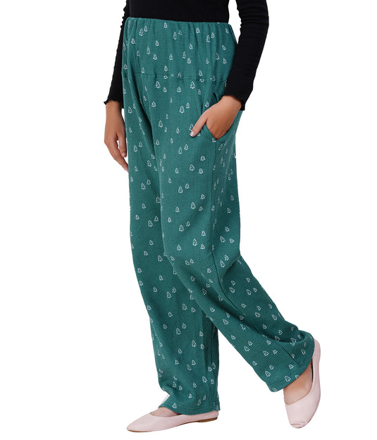 Green patterned pants worn by a person on a white background