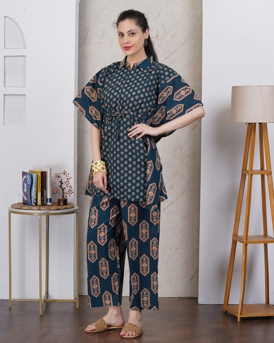 A woman wearing dark teal blue kurta set with matching pant.