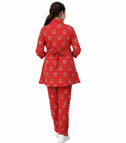 Red pajama set with cherry pattern and back knot on a white  background.