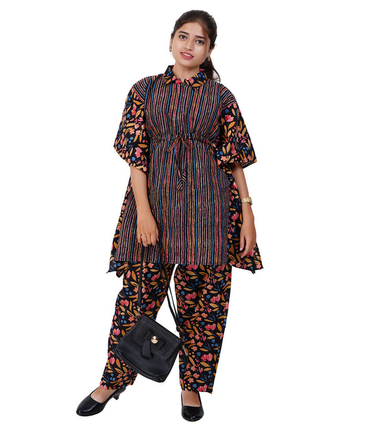 Woman wearing a colorful outfit with a black handbag on a white background