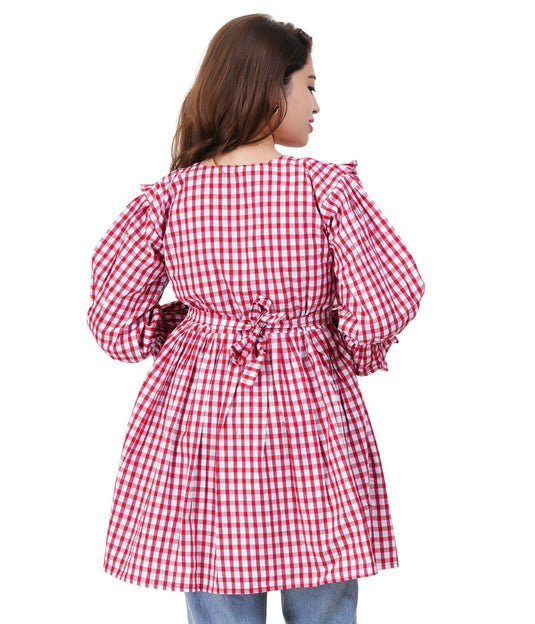 Red and white checkered dress worn by a person on a white background