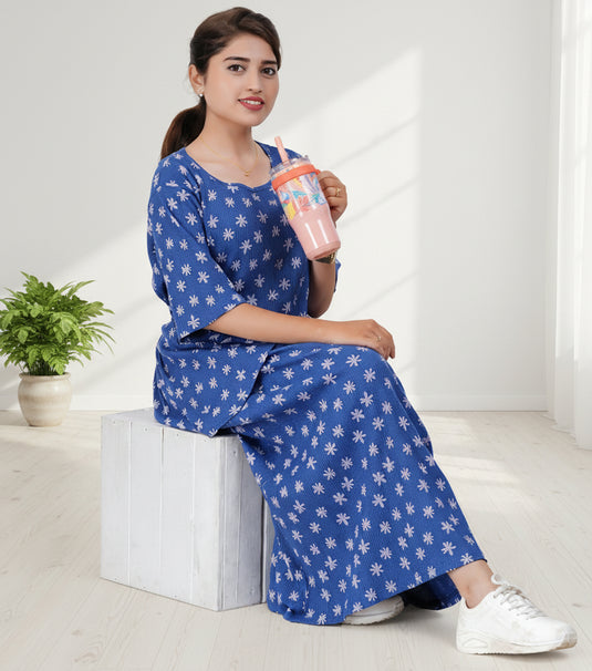 Woman wearing blue maxi dress and holding a cup 